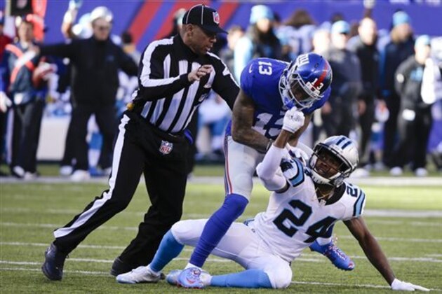 FILE - In this Dec. 20, 2015, file photo, a referee, left, separates New York Giants wide receiver Odell Beckham (13) and Carolina Panthers' Josh Norman (24) during the first half of an NFL football game Sunday, Dec. 20, 2015, in East Rutherford, N.J. In case you missed it, the top topics around the NFL after Week 15 include whether Beckham will be punished by the league for the way he attacked Norman during the Giants' loss to the unbeaten Panthers. (AP Photo/Julie Jacobson, File)
