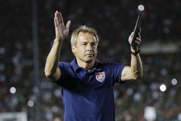 United States coach Jurgen Klinsmann acknowledges the fans after his team lost 2-3 to Mexico during the CONCACAF Cup playoff soccer match at the Rose Bowl Stadium, in Pasadena , Calif. Saturday, Oct. 10, 2015, (AP Photo/Jae C. Hong)