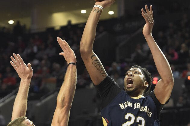 New Orleans Pelicans forward Anthony Davis (23) shoots over Portland Trail Blazers center Mason Plumlee (24) during the second half of an NBA basketball game in Portland, Ore., Monday, Dec. 14, 2015. The Trail Blazers won 105-101. (AP Photo/Steve Dykes)