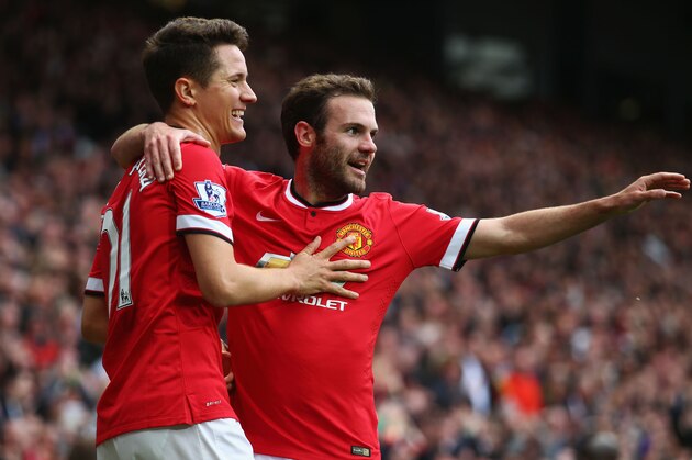 MANCHESTER, ENGLAND - MAY 17:  Ander Herrera of Manchester United celebrates with Juan Mata (R) as he scores their first goal during the Barclays Premier League match between Manchester United and Arsenal at Old Trafford on May 17, 2015 in Manchester, England.  (Photo by Clive Rose/Getty Images)