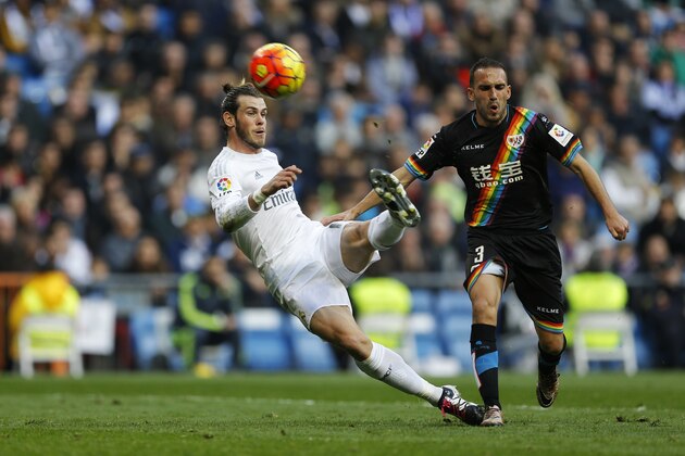 Real Madrid's shoots the ball to the goal next to Rayo Vallecano's Nacho Martinez, right, during the Spanish La Liga soccer match between Real Madrid and Rayo Vallecano at the Santiago Bernabeu stadium in Madrid, Sunday, Dec. 20, 2015. (AP Photo/Francisco Seco)