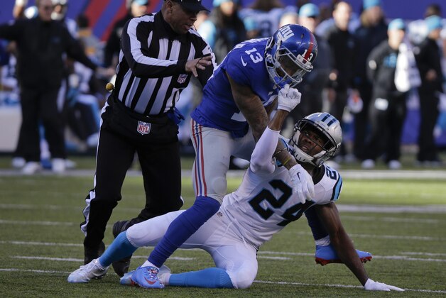 A referee steps in to separate New York Giants wide receiver Odell Beckham (13) and Carolina Panthers' Josh Norman (24) as they scuffle during the first half of an NFL football game Sunday, Dec. 20, 2015, in East Rutherford, N.J. (AP Photo/Julie Jacobson)