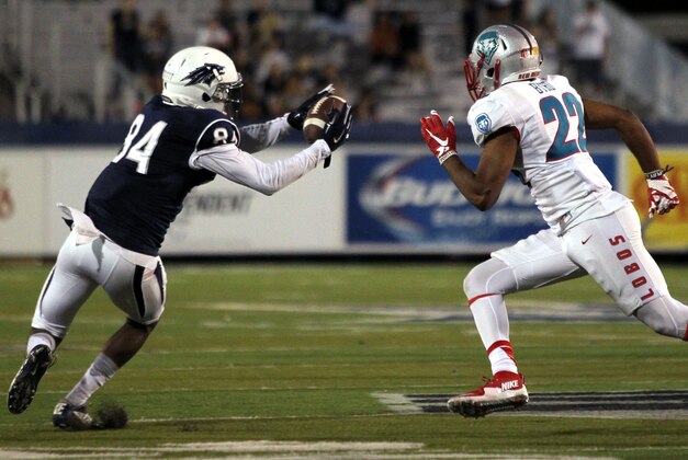 Oct 10, 2015; Reno, NV, USA; Nevada Wolf Pack wide receiver Jerico Richardson (84) catches a touchdown pass in front of New Mexico Lobos corner back Markel Byrd (22) in the fourth quarter of their NCAA football game at MacKay Stadium. Mandatory Credit: Lance Iversen-USA TODAY Sports