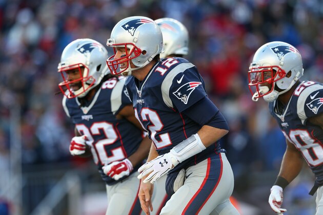 FOXBORO, MA - DECEMBER 20:  Tom Brady #12 of the New England Patriots runs off the field after throwing a touchdown pass during the first half against the Tennessee Titans at Gillette Stadium on December 20, 2015 in Foxboro, Massachusetts.  (Photo by Jim Rogash/Getty Images)