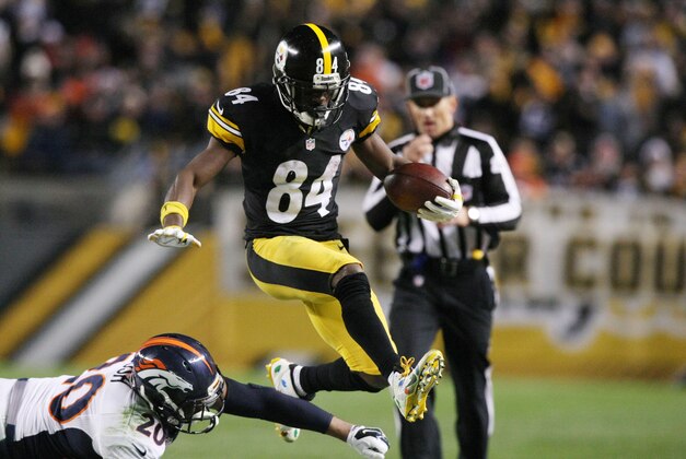 Dec 20, 2015; Pittsburgh, PA, USA; Pittsburgh Steelers wide receiver Antonio Brown (84) hurdles Denver Broncos safety Josh Bush (20) during the second half at Heinz Field. The Steelers won the game, 34-27. Mandatory Credit: Jason Bridge-USA TODAY Sports