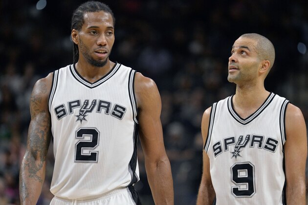 San Antonio Spurs forward Kawhi Leonard (2) and guard Tony Parker, of France, walk on the court during the second half of the Spurs' NBA basketball game against the Indiana Pacers, Monday, Dec. 21, 2015, in San Antonio. San Antonio won 106-92. (AP Photo/Darren Abate)