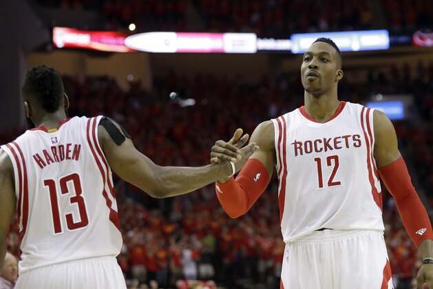 Houston Rockets guard James Harden (13) and center Dwight Howard (12) celebrate during the final moments against the Los Angeles Clippers in Game 7 of the NBA basketball Western Conference semifinals Sunday, May 17, 2015, in Houston. Houston won 113-100. (AP Photo/David J. Phillip)