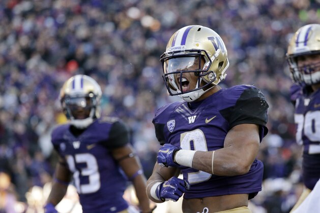 Washington's  Myles Gaskin celebrates after scoring a touchdown against Washington State in the second half of an NCAA college football game Friday, Nov. 27, 2015, in Seattle. Washington won the annual Apple Cup, 45-10. (AP Photo/Elaine Thompson)