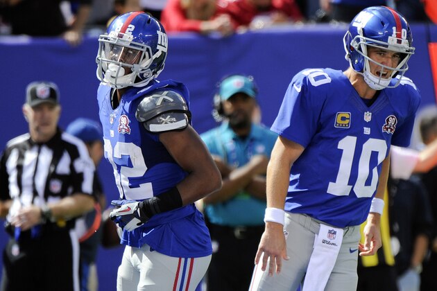New York Giants quarterback Eli Manning (10) and Rueben Randle (82) celebrate after they connected for a touchdown during the first half of an NFL football game against the Arizona Cardinals, Sunday, Sept. 14, 2014, in East Rutherford, N.J.  (AP Photo/Bill Kostroun)
