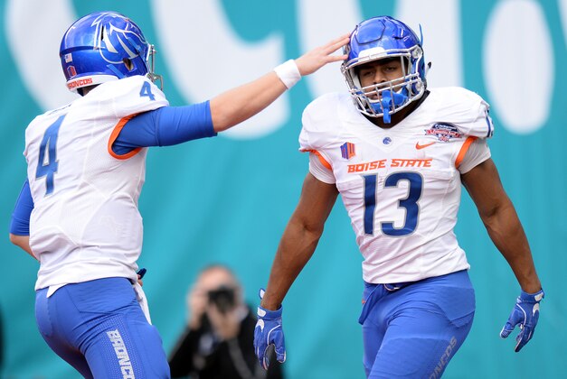Dec 23, 2015; San Diego, CA, USA; Boise State Broncos running back Jeremy McNichols (13) is congratulated by quarterback Brett Rypien (4) after scoring a touchdown during the first quarter against the Northern Illinois Huskies in the 2015 Poinsettia Bowl at Qualcomm Stadium. Mandatory Credit: Jake Roth-USA TODAY Sports