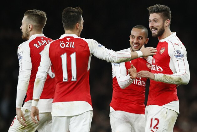 Arsenal's Theo Walcott, second right, is congratulated by teammates after scoring the opening goal of the game during the English Premier League soccer match between Arsenal and Manchester City at the Emirates stadium in London, Monday, Dec. 21, 2015. (AP Photo/Alastair Grant) Arsenal's Theo Walcott, second right, is congratulated by teammates after scoring the opening goal of the game during the English Premier League soccer match between Arsenal and Manchester City at the Emirates stadium in London, Monday, Dec. 21, 2015. (AP Photo/Alastair Grant)