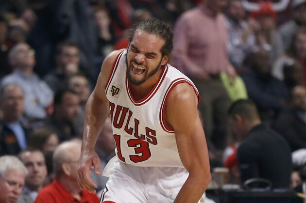Chicago Bulls center Joakim Noah runs down the court an apparently injured left shoulder during the second half of an NBA basketball game against the Brooklyn Nets on Monday, Dec. 21, 2015, in Chicago. The Nets won 105-102. (AP Photo/Charles Rex Arbogast)