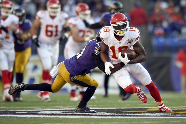 Kansas City Chiefs wide receiver Jeremy Maclin (19) tries to break free from Baltimore Ravens cornerback Lardarius Webb (21) as he rushes the ball in the first half of an NFL football game, Sunday, Dec. 20, 2015, in Baltimore. (AP Photo/Gail Burton)