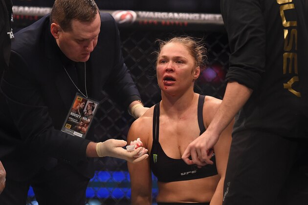 Nov 15, 2015; Melbourne, Australia; Ronda Rousey (red gloves) receives attention after being defeated by Holly Holm (not pictured) during UFC 193 at Etihad Stadium. Mandatory Credit: Matt Roberts-USA TODAY Sports