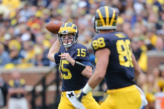 ANN ARBOR, MI - SEPTEMBER 12: Jake Rudock #15 of the Michigan Wolverines rolls out to pass to Jake Butt #88 during the game against the Oregon State Beavers on September 12, 2015 at Michigan Stadium in Ann Arbor, Michigan. (Photo by Leon Halip/Getty Images)