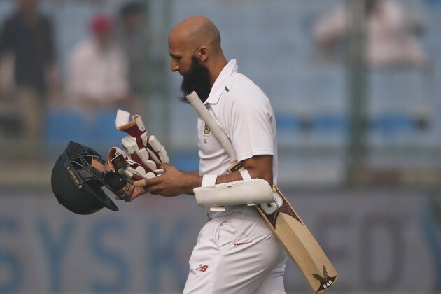 South Africa's captain Hashim Amla, walks back after his dismissal on the last day of their fourth and final test cricket match against India in New Delhi, India, Monday, Dec. 7, 2015. (AP Photo/Tsering Topgyal)