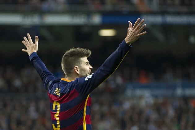 Barcelona's defender Gerard Pique gestures during the Spanish league 'Clasico' football match Real Madrid CF vs FC Barcelona at the Santiago Bernabeu stadium in Madrid on November 21, 2014.    AFP PHOTO / CURTO DE LA TORRE        (Photo credit should read CURTO DE LA TORRE/AFP/Getty Images)