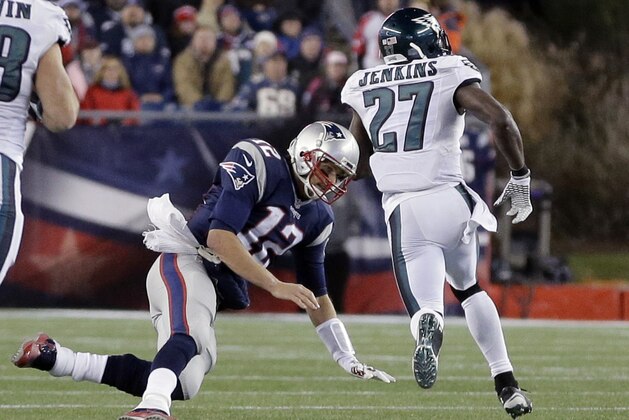 Philadelphia Eagles safety Malcolm Jenkins runs past a tackle attempt by New England Patriots quarterback Tom Brady (12) with a 100-yard interception return for a touchdown during the second half of an NFL football game, Sunday, Dec. 6, 2015, in Foxborough, Mass. (AP Photo/Steven Senne)