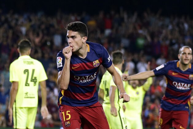 FC Barcelona's Marc Bartra celebrates after scoring against Levante during a Spanish La Liga soccer match at the Camp Nou stadium in Barcelona, Spain, Sunday, Sept. 20, 2015. (AP Photo/Manu Fernandez)