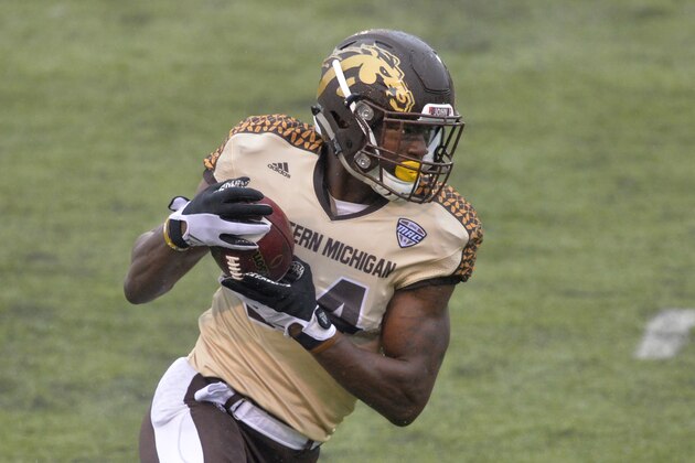 FILE -- In this Nov. 27, 2015, file photo, Western Michigan wide receiver Corey Davis runs with the ball for a 30-yard touchdown reception against Toledo in an NCAA college football game in Toledo, Ohio. The inaugural Bahamas Bowl last season featured a combined 12 touchdown passes and a stunning three-lateral, 75-yard score as time expired before Western Kentucky escaped with a 49-48 victory over Central Michigan. Thursday’s matchup between Middle Tennessee and Western Michigan features two of the nation’s most prolific receiving tandems. (AP Photo/David Richard, File)