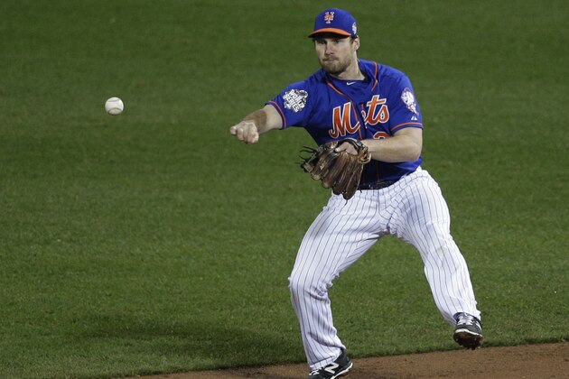 New York Mets second baseman Daniel Murphy throws to second on a double play on a hit by Kansas City Royals' Alcides Escobar during the third inning of Game 5 of the Major League Baseball World Series Sunday, Nov. 1, 2015, in New York. (AP Photo/Julie Jacobson)