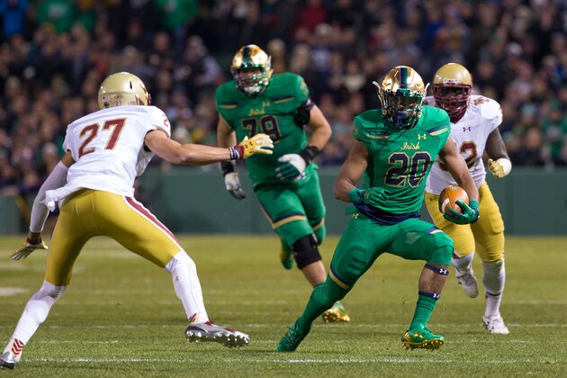 BOSTON, MA - NOVEMBER 21: C.J. Prosise #20 of the Notre Dame Fighting Irish runs with the ball against Justin Simmons #27 of the Boston College Eagles at Fenway Park during the 'Shamrock Series' on November 21, 2015 in Boston, Massachusetts. The Fighting Irish won 19-16.(Photo by Richard T Gagnon/Getty Images)