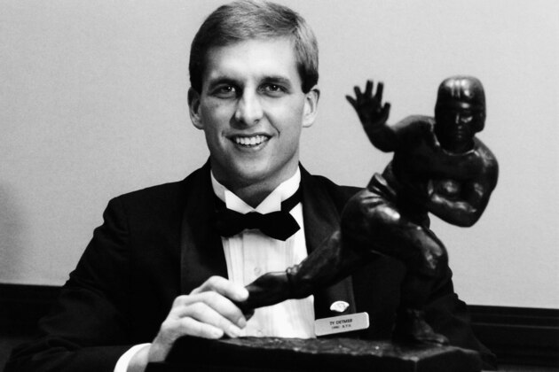 Ty Detmer, shown here with the Heisman Trophy he won earlier this year, was named the winner of the Maxwell Club Award in Philadelphia Dec. 13, 1990, as the nation's outstanding college football player. Detmer, a junior at Brigham Young University broke 21 school passing records as quarterback. (AP Photo)