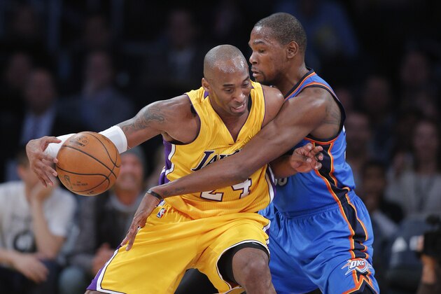 Los Angeles Lakers' Kobe Bryant, left, is defended by Oklahoma City Thunder's Kevin Durant during the first half of an NBA basketball game, Wednesday, Dec. 23, 2015, in Los Angeles. (AP Photo/Jae C. Hong)