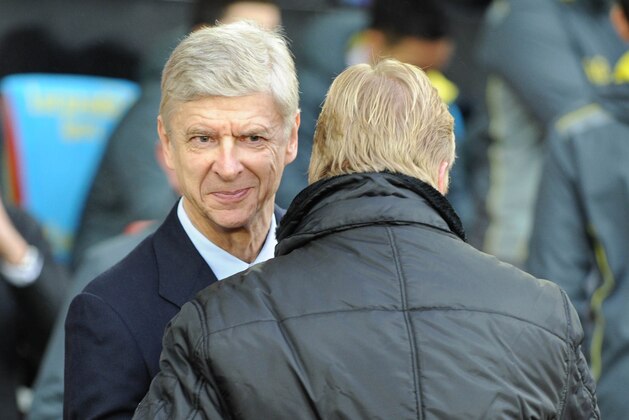 Southampton's Dutch manager Ronald Koeman (R) greets Arsenal's French manager Arsene Wenger (L) during the English Premier League football match between Southampton and Arsenal at St Mary's Stadium in Southampton, southern England, on January 1, 2015. AFP PHOTO / OLLY GREENWOOD 

== RESTRICTED TO EDITORIAL USE. NO USE WITH UNAUTHORIZED AUDIO, VIDEO, DATA, FIXTURE LISTS, CLUB/LEAGUE LOGOS OR LIVE SERVICES. ONLINE IN-MATCH USE LIMITED TO 45 IMAGES, NO VIDEO EMULATION. NO USE IN BETTING, GAMES OR SINGLE CLUB/LEAGUE/PLAYER PUBLICATIONS. ==        (Photo credit should read OLLY GREENWOOD/AFP/Getty Images)