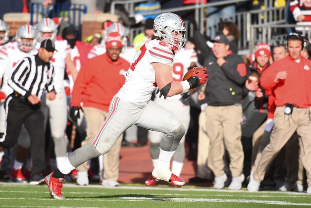 Nov 28, 2015; Ann Arbor, MI, USA; Ohio State Buckeyes defensive lineman Joey Bosa (97) runs the ball after an interception during the game against the Michigan Wolverines at Michigan Stadium. Mandatory Credit: Tim Fuller-USA TODAY Sports