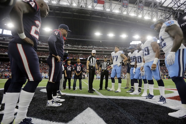 Houston Texans and Tennessee Titans players meet at midfield for the coin toss before an NFL football game, Sunday, Nov. 1, 2015, in Houston. (AP Photo/Patric Schneider)