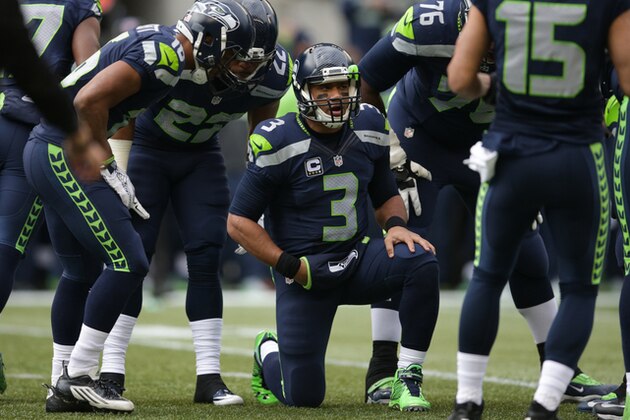 Seattle Seahawks quarterback Russell Wilson talks in the huddle in the first half of an NFL football game against the Cleveland Browns, Sunday, Dec. 20, 2015, in Seattle. (AP Photo/Scott Eklund)