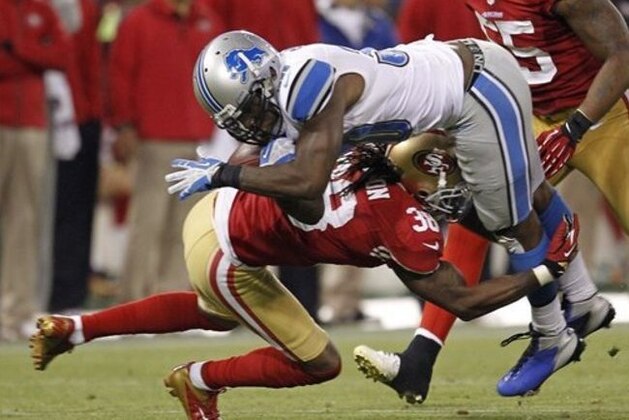 Detroit Lions running back Kevin Smith, top,  is upended by San Francisco 49ers free safety Dashon Goldson, bottom, during the third quarter of an NFL football game in San Francisco, Sunday, Sept. 16, 2012. (AP Photo/Tony Avelar)