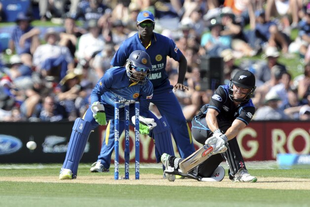 New Zealand’s Henry Nichols sweeps in front of Sri Lanka’s Dinesh Chandimal in their first One Day International cricket match at Hagley Park Oval in Christchurch, New Zealand, Saturday, Dec. 26, 2015. (Ross Setford/SNPA via AP) NEW ZEALAND OUT