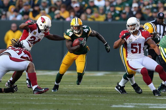 GREEN BAY, WI - NOVEMBER 04:  James Starks #44 of the Green Bay Packers runs between Adrian Wilson #24 and Paris Lenon #51 of the Arizona Cardinals at Lambeau Field on November 4, 2012 in Green Bay, Wisconsin. The Packers defeated the Cardinals 31-17.  (Photo by Jonathan Daniel/Getty Images)