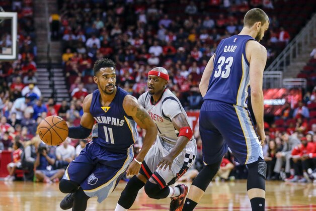 Memphis Grizzlies guard Mike Conley (11) drives around Houston Rockets guard Jason Terry (31) in the first half of an NBA basketball game, Wednesday, Nov. 25, 2015 in Houston. (AP Photo/Bob Levey)