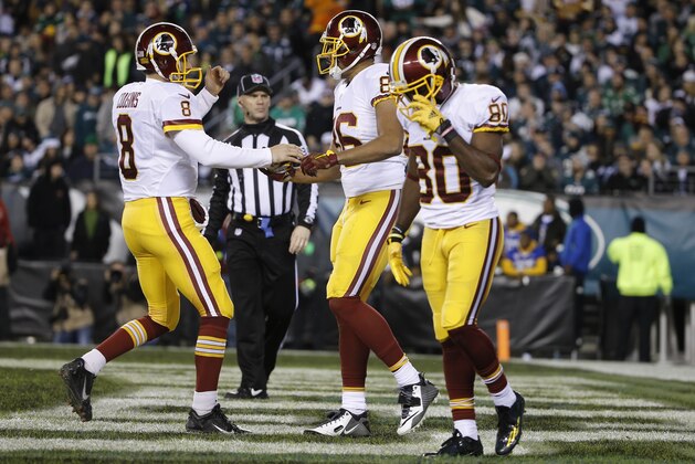 Washington Redskins' Kirk Cousins (8) and Jordan Reed (86) celebrate after Reed's touchdown catch in the first half of an NFL football game against the Philadelphia Eagles, Saturday, Dec. 26, 2015, in Philadelphia.  (AP Photo/Matt Rourke)