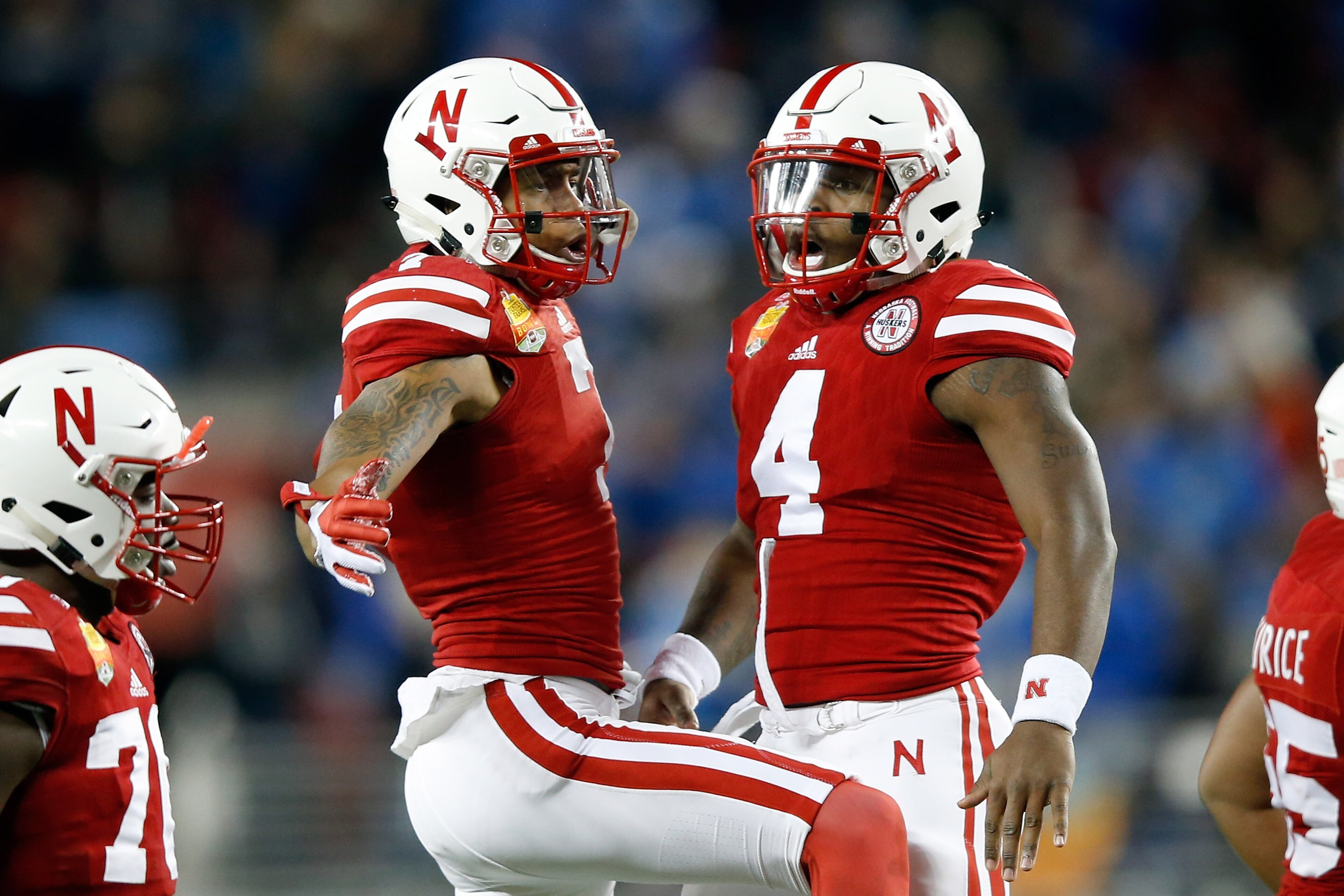 SANTA CLARA, CA - DECEMBER 26:  Taariq Allen #7 and Tommy Armstrong Jr. #4 of the Nebraska Cornhuskers celebrate after the Cornhuskers scored a touchdown against the UCLA Bruins during the Foster Farms Bowl at Levi's Stadium on December 26, 2015 in Santa Clara, California.  (Photo by Ezra Shaw/Getty Images)
