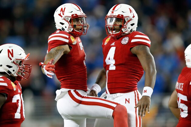 SANTA CLARA, CA - DECEMBER 26:  Taariq Allen #7 and Tommy Armstrong Jr. #4 of the Nebraska Cornhuskers celebrate after the Cornhuskers scored a touchdown against the UCLA Bruins during the Foster Farms Bowl at Levi's Stadium on December 26, 2015 in Santa Clara, California.  (Photo by Ezra Shaw/Getty Images)