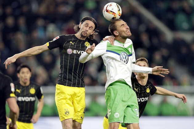 Dortmund's Neven Subotic, left, and Wolfsburg's Bas Dost, right, go for a header during the German Bundesliga soccer match between VfL Wolfsburg and Borussia Dortmund in Wolfsburg, Germany, Saturday, Dec. 5, 2015. (AP Photo/Michael Sohn) Dortmund's Neven Subotic, left, and Wolfsburg's Bas Dost, right, go for a header during the German Bundesliga soccer match between VfL Wolfsburg and Borussia Dortmund in Wolfsburg, Germany, Saturday, Dec. 5, 2015. (AP Photo/Michael Sohn)
