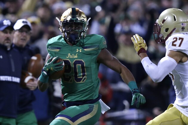 Notre Dame running back C.J. Prosise (20) runs during the first half of the Shamrock Series NCAA college football game at Fenway Park, home of the Boston Red Sox, in Boston Saturday, Nov. 21, 2015. (AP Photo/Charles Krupa)