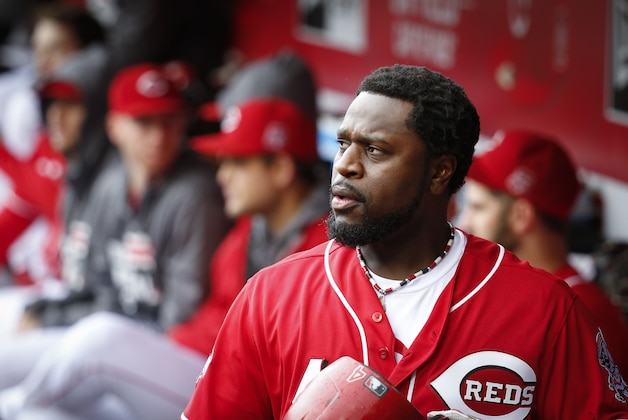 Cincinnati Reds second baseman Brandon Phillips walks through the dugout in the sixth inning of a baseball game against the Chicago Cubs, Thursday, Oct. 1, 2015, in Cincinnati. The Cubs won 5-3. (AP Photo/John Minchillo)
