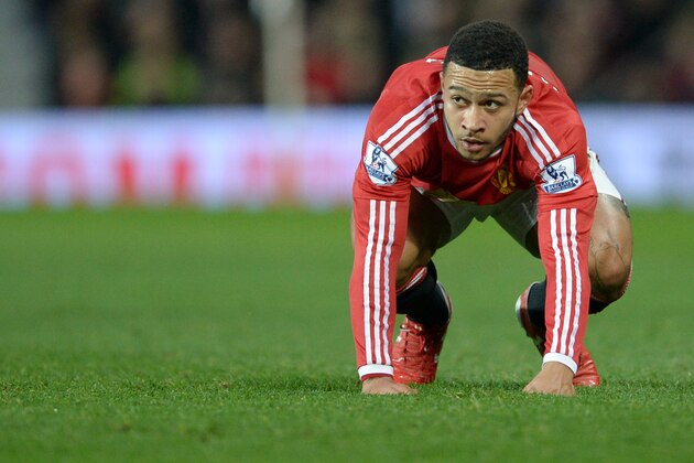 Manchester United's Dutch striker Memphis Depay reacts after missing a chance during the English Premier League football match between Manchester United and Norwich City at Old Trafford in Manchester, north west England on December 19, 2015. Norwich won the game 2-1. AFP PHOTO / OLI SCARFF

RESTRICTED TO EDITORIAL USE. NO USE WITH UNAUTHORIZED AUDIO, VIDEO, DATA, FIXTURE LISTS, CLUB/LEAGUE LOGOS OR 'LIVE' SERVICES. ONLINE IN-MATCH USE LIMITED TO 75 IMAGES, NO VIDEO EMULATION. NO USE IN BETTING, GAMES OR SINGLE CLUB/LEAGUE/PLAYER PUBLICATIONS. / AFP / OLI SCARFF        (Photo credit should read OLI SCARFF/AFP/Getty Images)