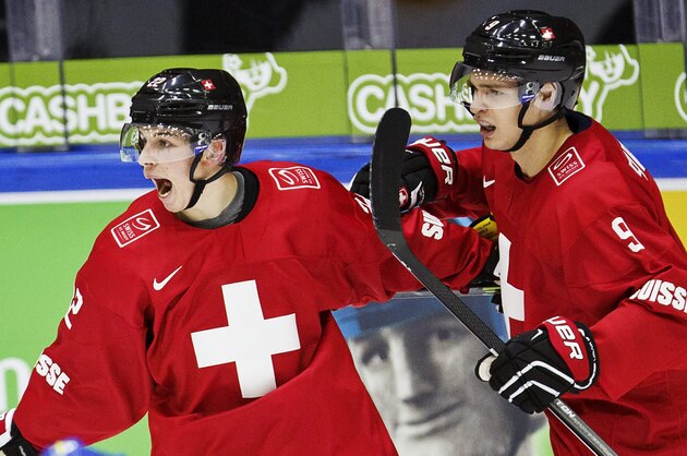 Switzerland's Tino Kessler, left, celebrates scoring with teammate Marco Forrer during the 2016 IIHF World Junior Ice Hockey Championship match between Switzerland and Sweden in Helsinki, Finland, Saturday Dec. 26, 2015. (Roni Rekomaa/Lehtikuva via AP) FINLAND OUT