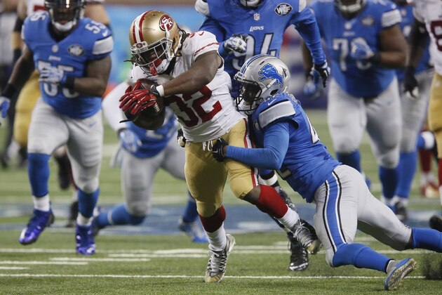 San Francisco 49ers running back DuJuan Harris is tackled by Detroit Lions strong safety Isa Abdul-Quddus during the first half of an NFL football game, Sunday, Dec. 27, 2015, in Detroit. (AP Photo/Duane Burleson)