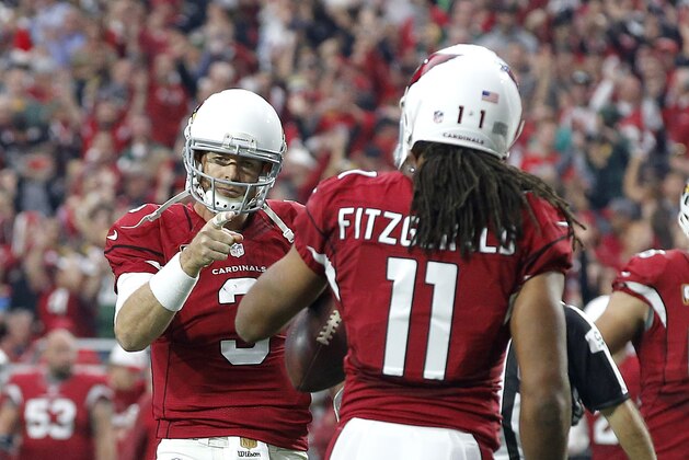 Arizona Cardinals quarterback Carson Palmer (3) points to wide receiver Larry Fitzgerald (11) after a touchdown catch during the first half of an NFL football game against the Green Bay Packers, Sunday, Dec. 27, 2015, in Glendale, Ariz. (AP Photo/Ross D. Franklin)