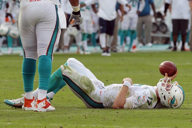 Miami Dolphins quarterback Ryan Tannehill (17) lies on the field after a sack during the final seconds of the second half of an NFL football game against the Indianapolis Colts, Sunday, Dec. 27, 2015, in Miami Gardens, Fla. The Colts defeated the Dolphins 18-12. (AP Photo/Lynne Sladky)