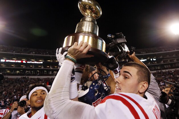 Mississippi quarterback Chad Kelly, right, and Mississippi defensive back Cameron Ordway, hoist the Egg Bowl trophy as they celebrate a 38-27 win over Mississippi State in an NCAA college football game in Starkville, Miss., Saturday, Nov. 28, 2015. (AP Photo/Rogelio V. Solis)