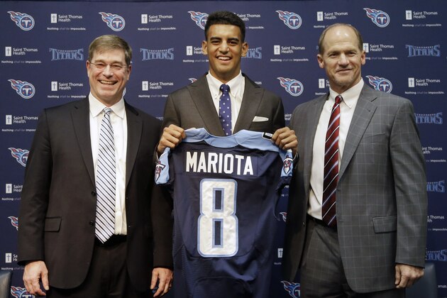 Marcus Mariota, center, former Oregon quarterback and overall No. 2 NFL football draft pick by the Tennessee Titans, poses with head coach Ken Whisenhunt, right, and general manager Ruston Webster, left, during a news conference Friday, May 1, 2015, in Nashville, Tenn. Mariota was selected by the Titans in the first round Thursday. (AP Photo/Mark Humphrey)