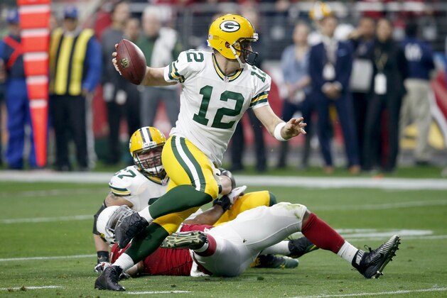 Green Bay Packers quarterback Aaron Rodgers (12) scrambles against the Arizona Cardinals during the first half of an NFL football game, Sunday, Dec. 27, 2015, in Glendale, Ariz. (AP Photo/Rick Scuteri)